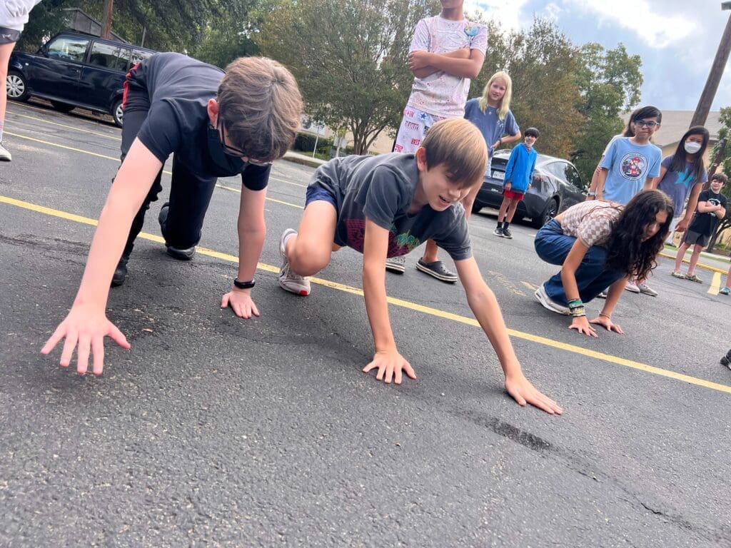 Middle Schoolers get outdoors and put hands on street at project based school.