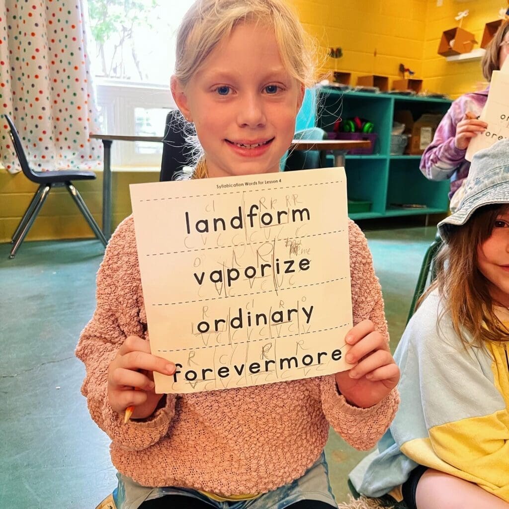 Second grader holds language arts assignment at alternative school.
