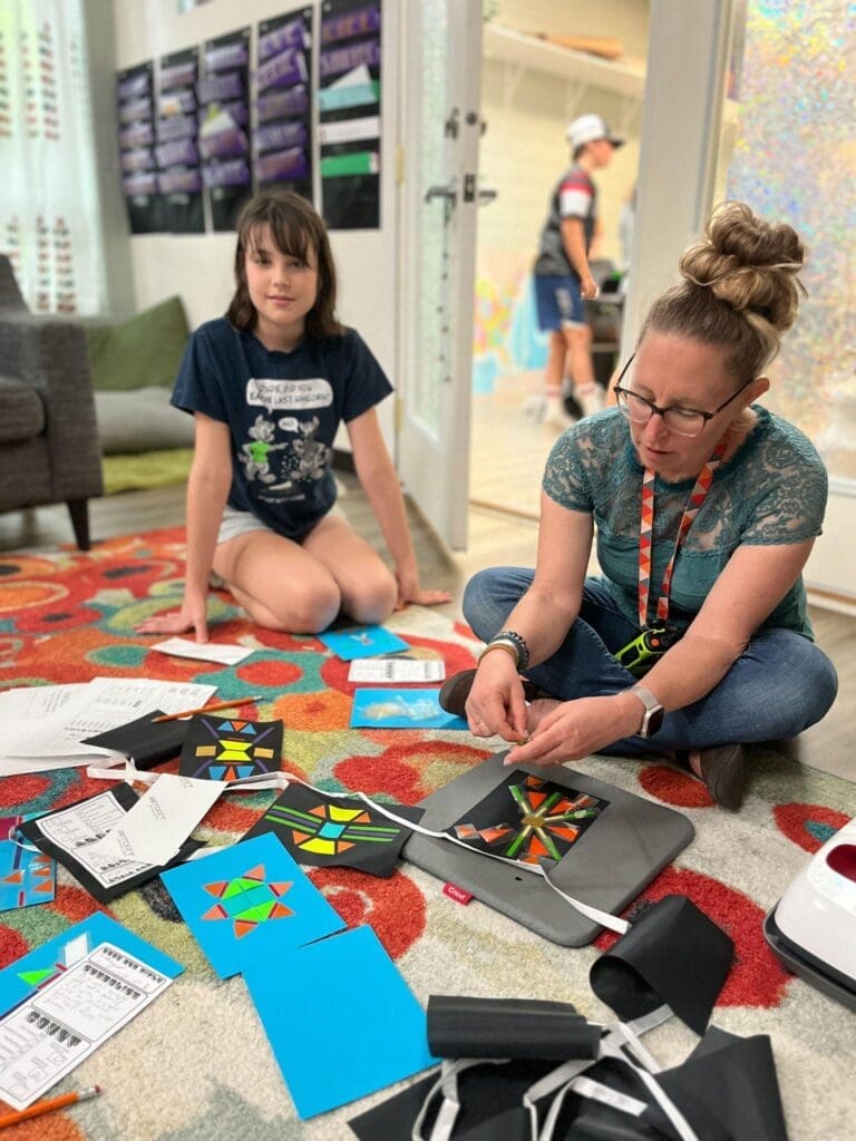 Math teacher sits on floor at micro school in Austin.