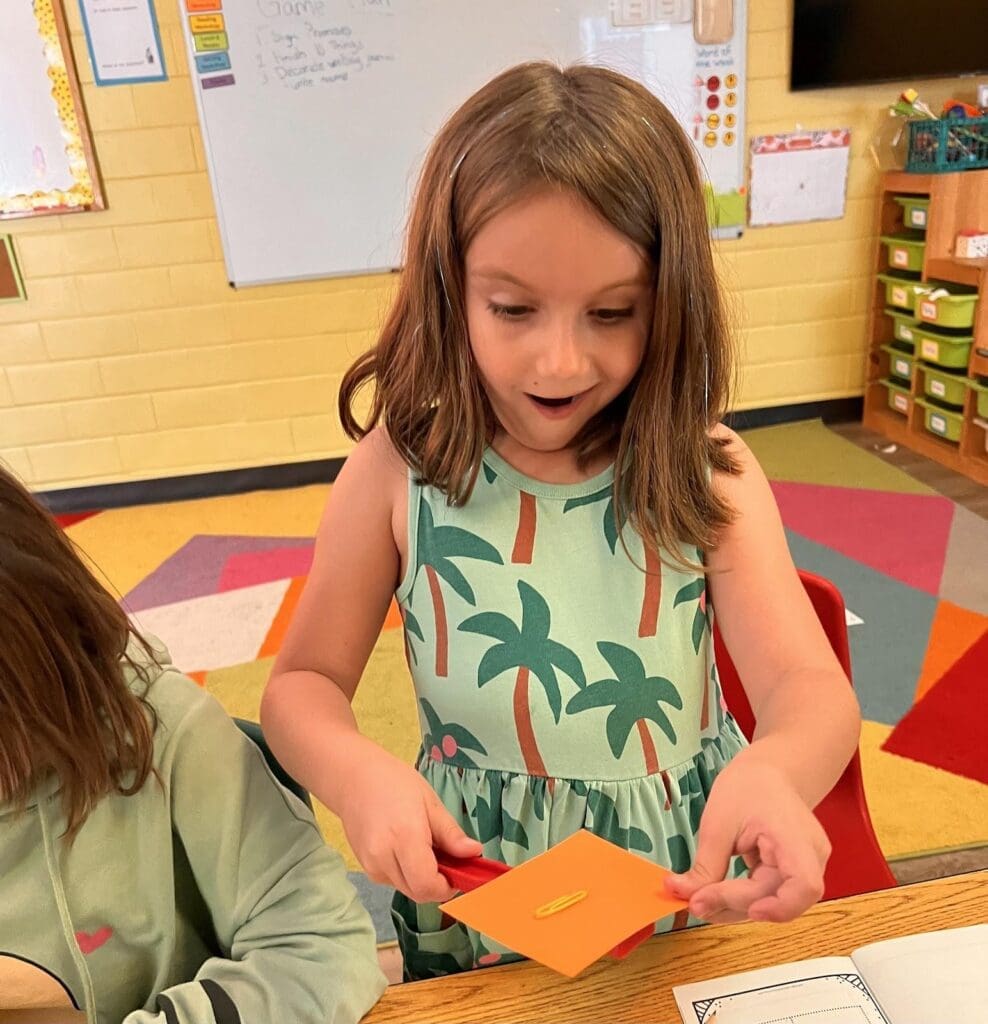 Second grade girl looks surprised at project based school.