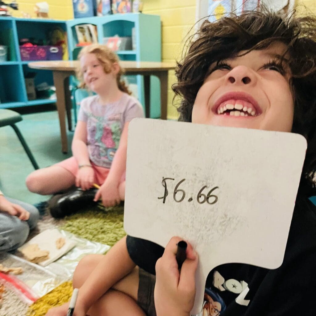 Elementary student smiles proudly at private school in Austin.