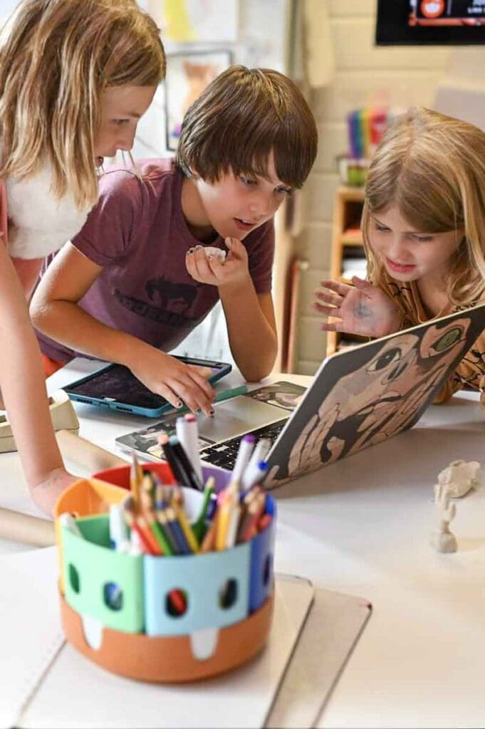 Three elementary students work together at project based school.