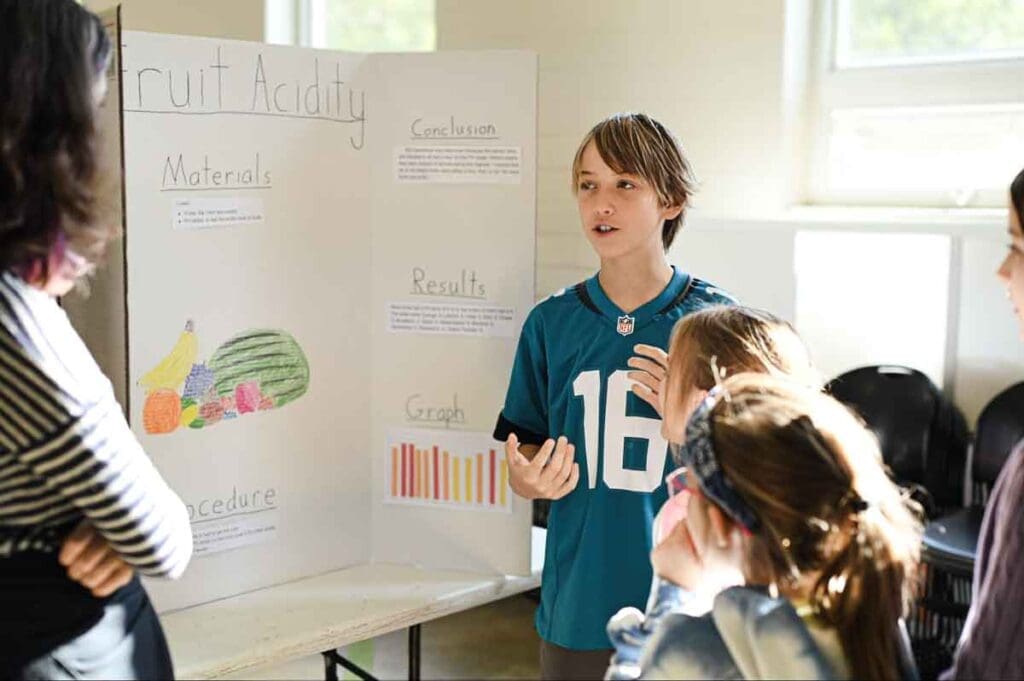 Student in gifted and talented program explains STEM project to middle schoolers.