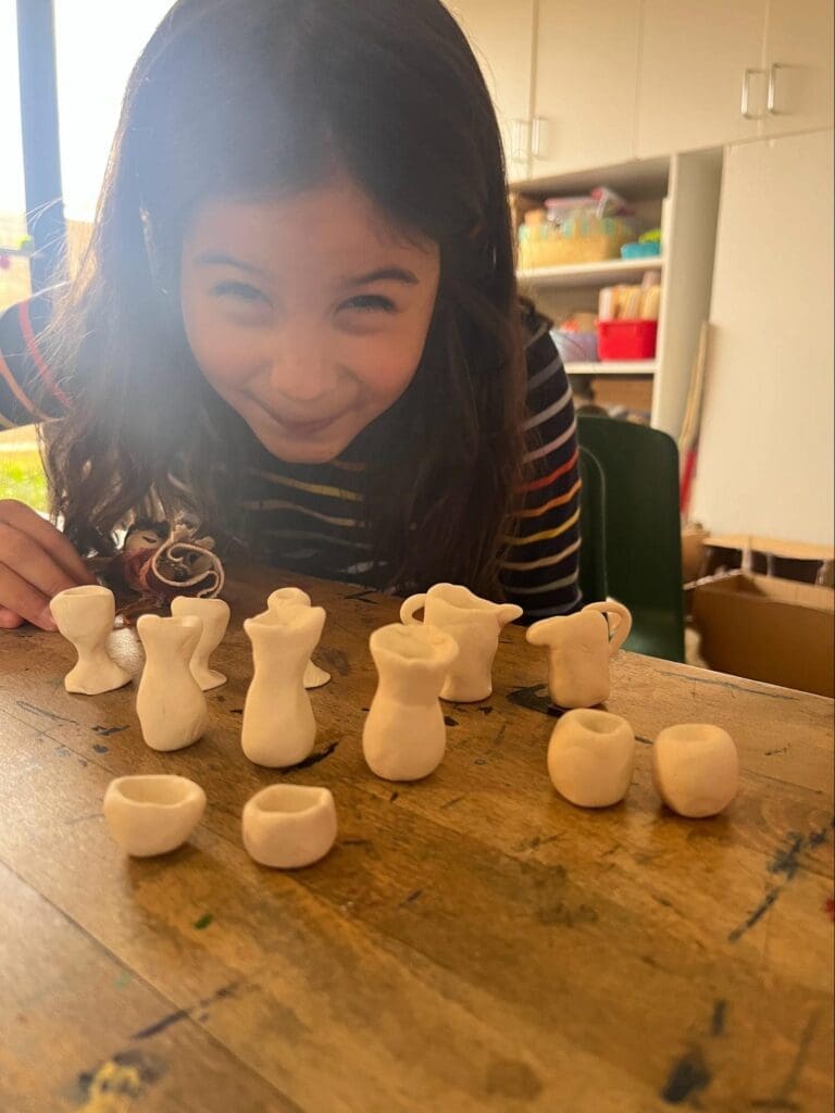 Elementary student displays clay crafts at project based school in Austin.