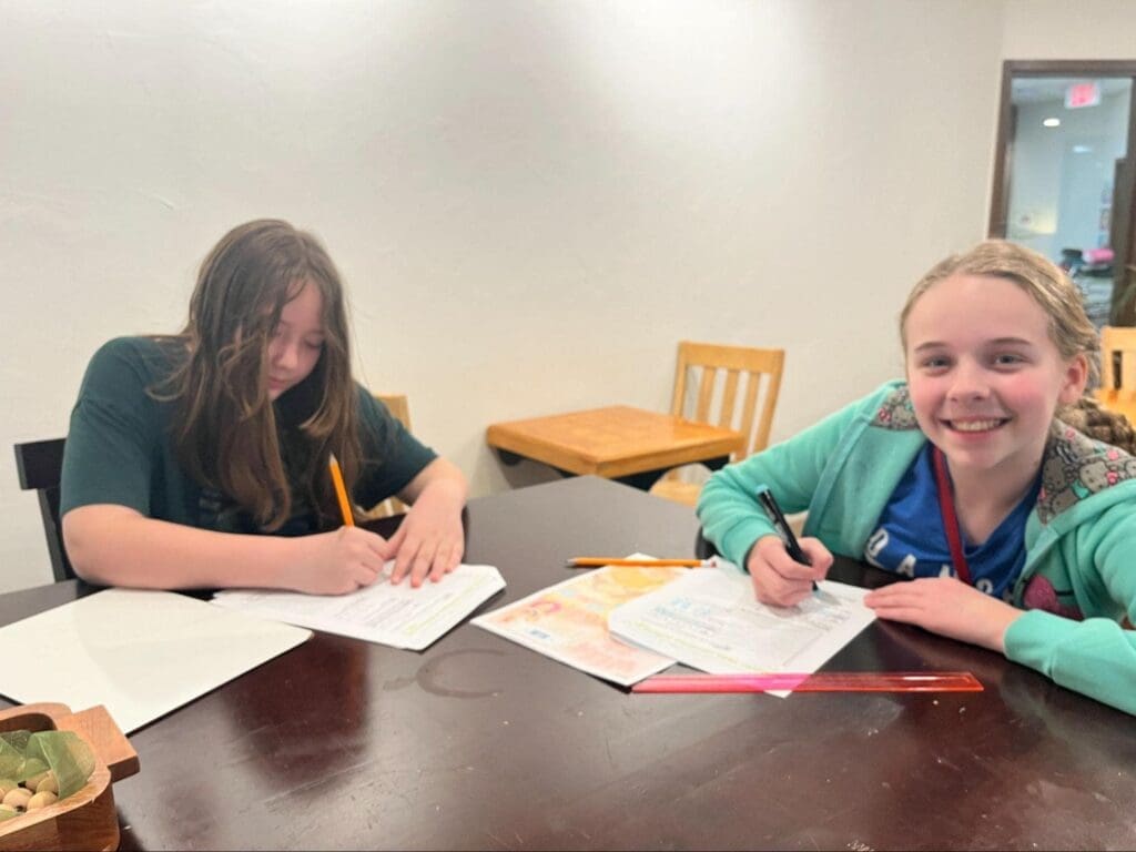 Two middle schoolers work on worksheets at private school in Austin.