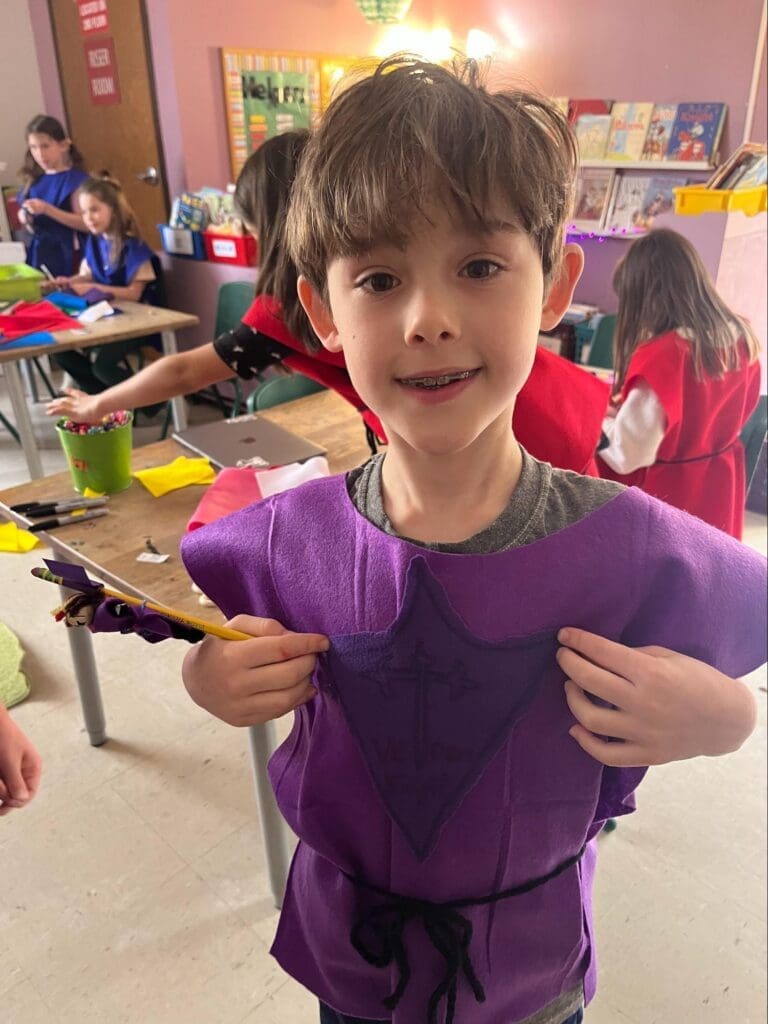 Elementary student proudly displays outfit at project based school.