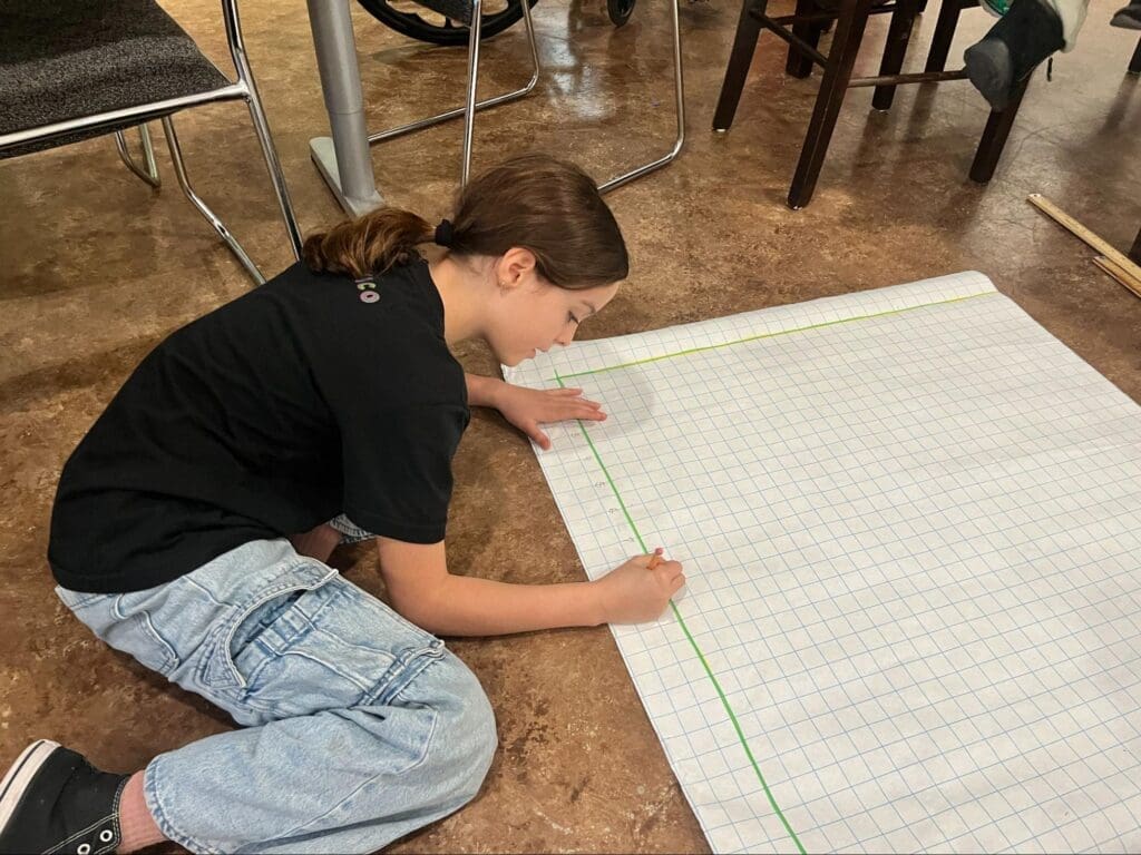 Middle school student works with graphing paper at GT school in Austin