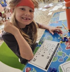 Kindergarten student works on math at STEM school.