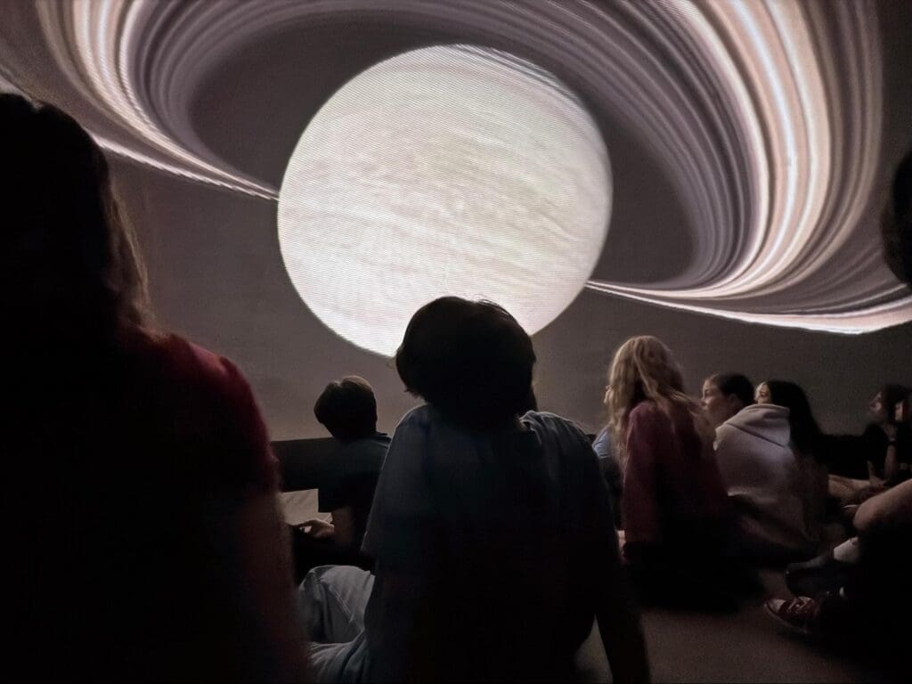 Middle school students participate in on campus planetarium at private school in Austin.
