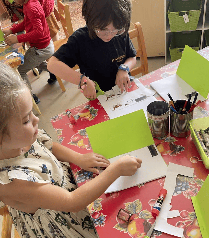 Kindergarten child cuts paper at private school in Austin