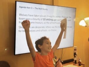 Middle school boy raises arms at nonreligious school.